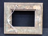 a picture of an old picture frame with a rope