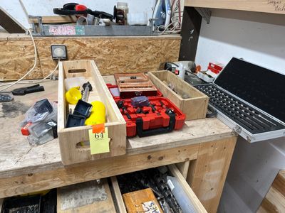 un établi sur lequel se trouvent des outils et un ordinateur portable