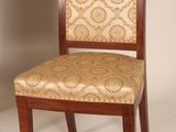 two wooden chairs with patterned upholstered upholstered seats