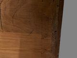 a close up of a piece of wood with writing on it