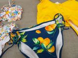 a yellow top and a blue bikini with oranges on it