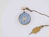a blue and gold pocket watch with a key on a chain