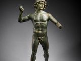 an image of a bronze statue of a man holding a sword