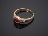 a gold ring with a ruby stone and diamonds