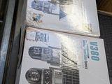 two boxes of remotes sitting on top of a conveyor belt