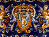 a blue and yellow plate with angels on it