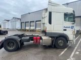 a white semi truck parked in a parking lot
