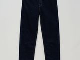 a pair of dark blue jeans hanging on a white wall