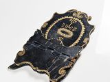 a black and gold plaque with a dragon on it