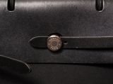 the back of a black briefcase with a metal lock on it