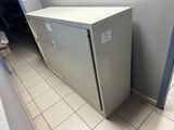 a metal cabinet in the corner of a room