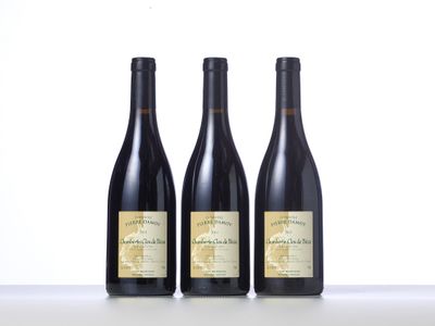 three bottles of wine are lined up on a table