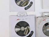 four different types of circular saw blades in a box on a white surface