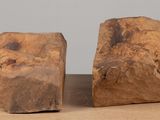 two pieces of wood sitting on top of a table next to each other