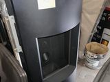 an image of a black stove in a garage