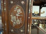 a wooden cabinet with a mirror on top of it