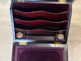 a wooden box that has a bunch of items inside of it