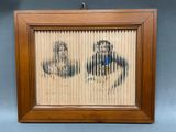 painting of a man and a woman in a wooden frame on a wall