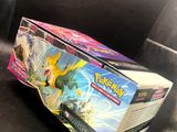 two pokemon cards are sitting on a black tray on a table