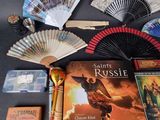 a table with a bunch of books and a fan on it