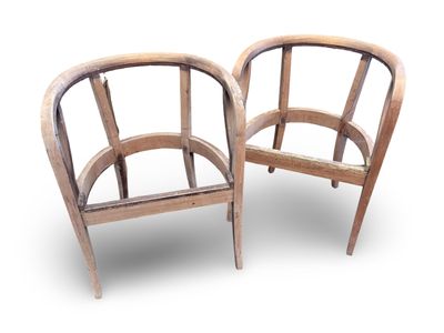 two wooden chairs sitting next to each other on a white surface