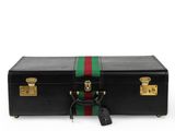 a black suitcase with a green, red and green stripe on the side