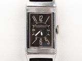 a close up of a watch on a white surface