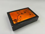 une petite boîte sur laquelle est représentée une peinture d'oiseaux