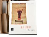 books in a cardboard box on a white background with a picture of a man standing on a chair