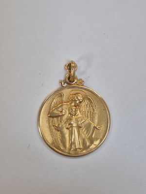 a close up of a gold medal with an angel on it