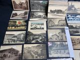 several old black and white photographs of people and buildings on a table