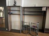 a closet with a mirror and a chair in the room