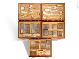 many different types of silverware in a wooden box