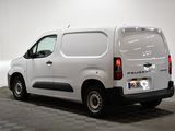 the white van is parked in a clean room with a checkered floor
