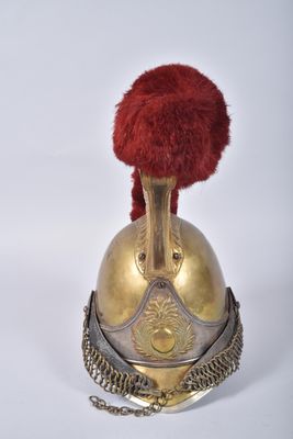 an old helmet with a red pom - pom on top of it