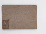 a piece of brown paper on a white surface