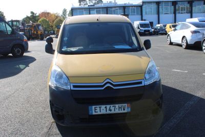 a small yellow van parked in a parking lot