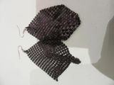 a pair of earrings made out of beads on a mannequin mannequin mannequin mannequin mannequin mannequin manne