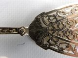 a silver spoon that is sitting on a white surface