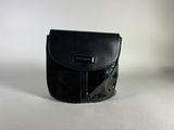 black leather purse on a white surface with a white background