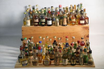 de nombreuses bouteilles d'alcool posées sur une étagère en bois