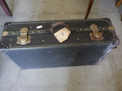 a black suitcase sitting on the floor with a tag on it