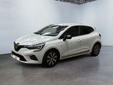 a white car is parked in a white room with a black floor