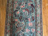 un tapis posé par terre, à côté d'une boîte et d'une paire de chaussures