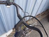 a close up of a bicycle handlebar with a clock on it
