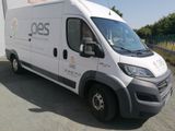 a white van that is parked in front of a building