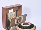 a small wooden box with a camera inside of it