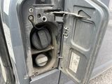 a close up of a car door with a gas pump in it