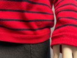 red and black striped sweater on mannequin head