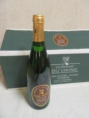a bottle of wine that is sitting next to a box